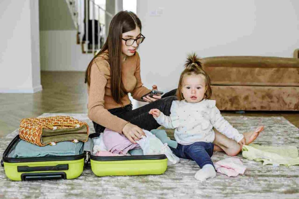 A young parent packing a suitcase and learning about the importance of legal planning for minor children